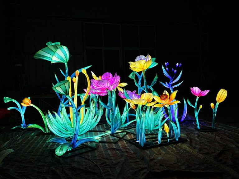 A lantern garden composed of tulips and other plants.