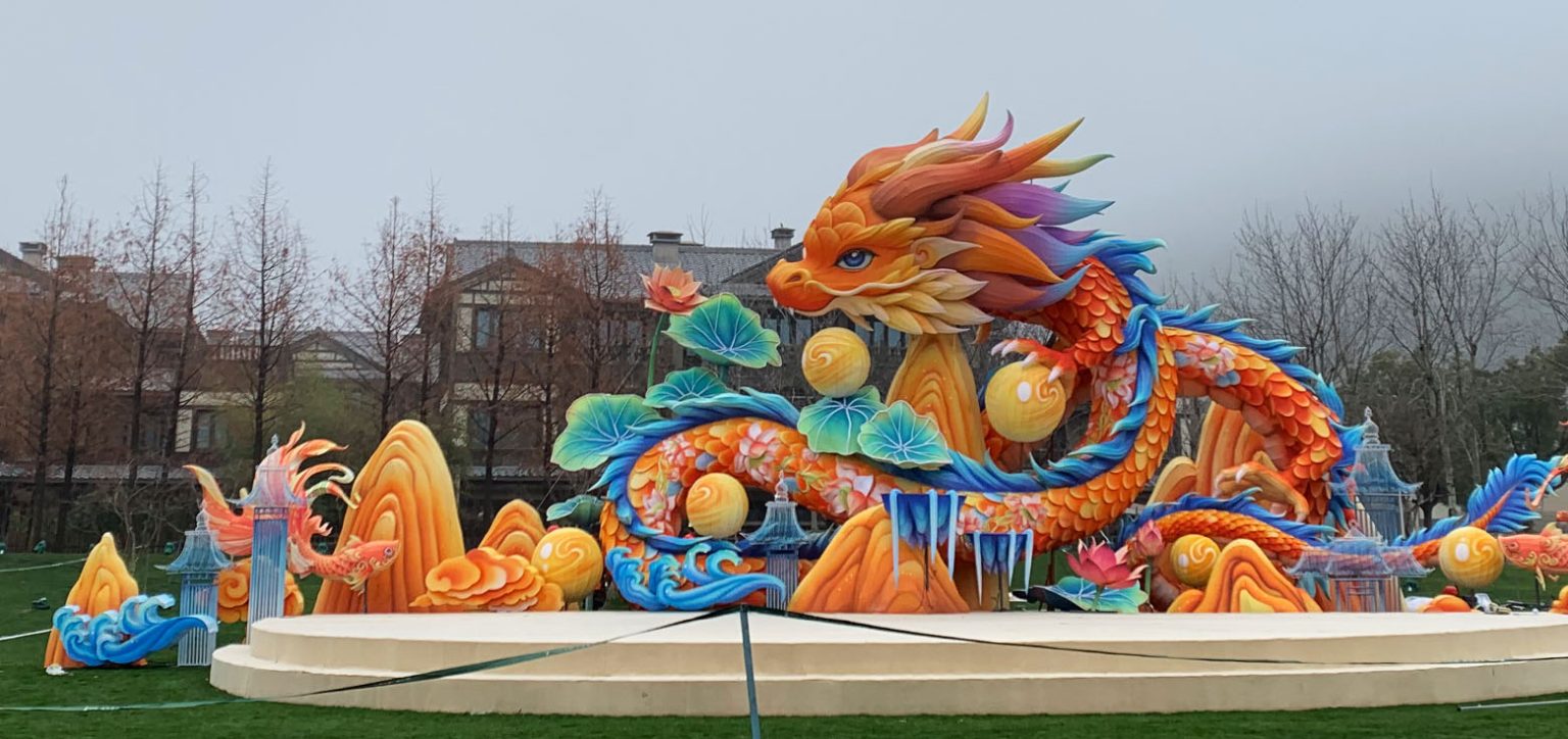 A huge dragon lantern set, custom-made for the New Year celebration, is coiled upon the stage.