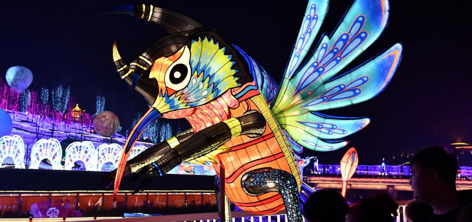 A large, visually stunning Chinese lantern lights installation in the shape of a bee.