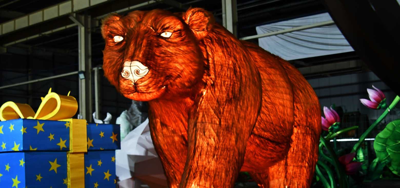 An artistic, modern lantern shaped like a brown bear.