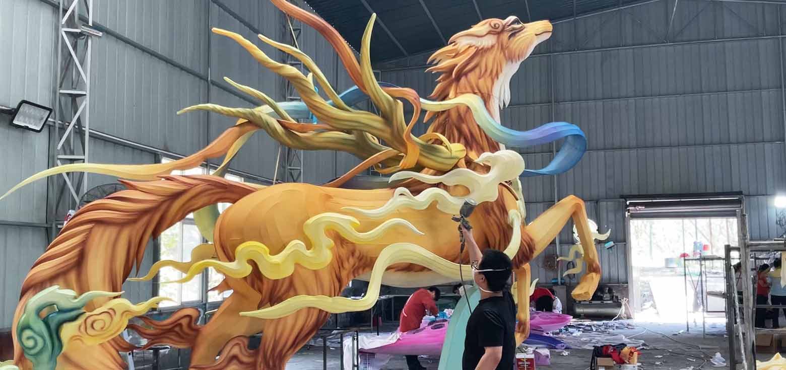 Mythical creature-themed Chinese lanterns are being colored.