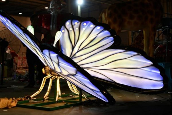 Blue butterfly insect lantern undergoing lighting effect testing.