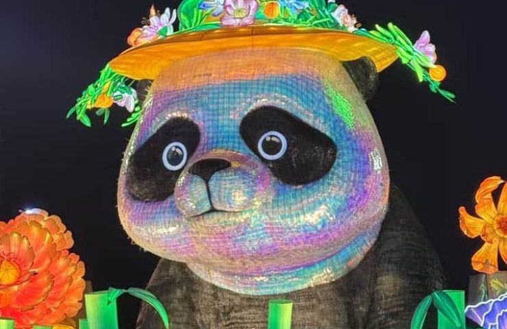 A giant panda lantern wearing a floral hat, representing iconic cultural symbols.