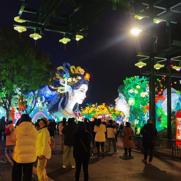 Two gigantic Chinese New Year lanterns shaped like human figures.