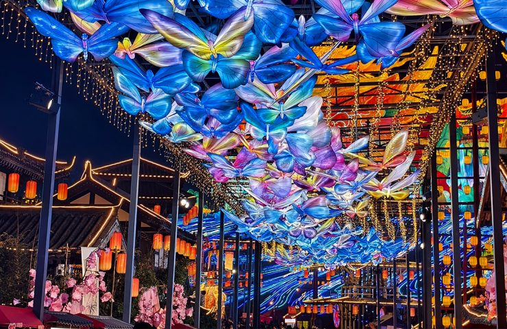 Glowing butterfly lantern canopy during a Mid Autumn Festival celebration.